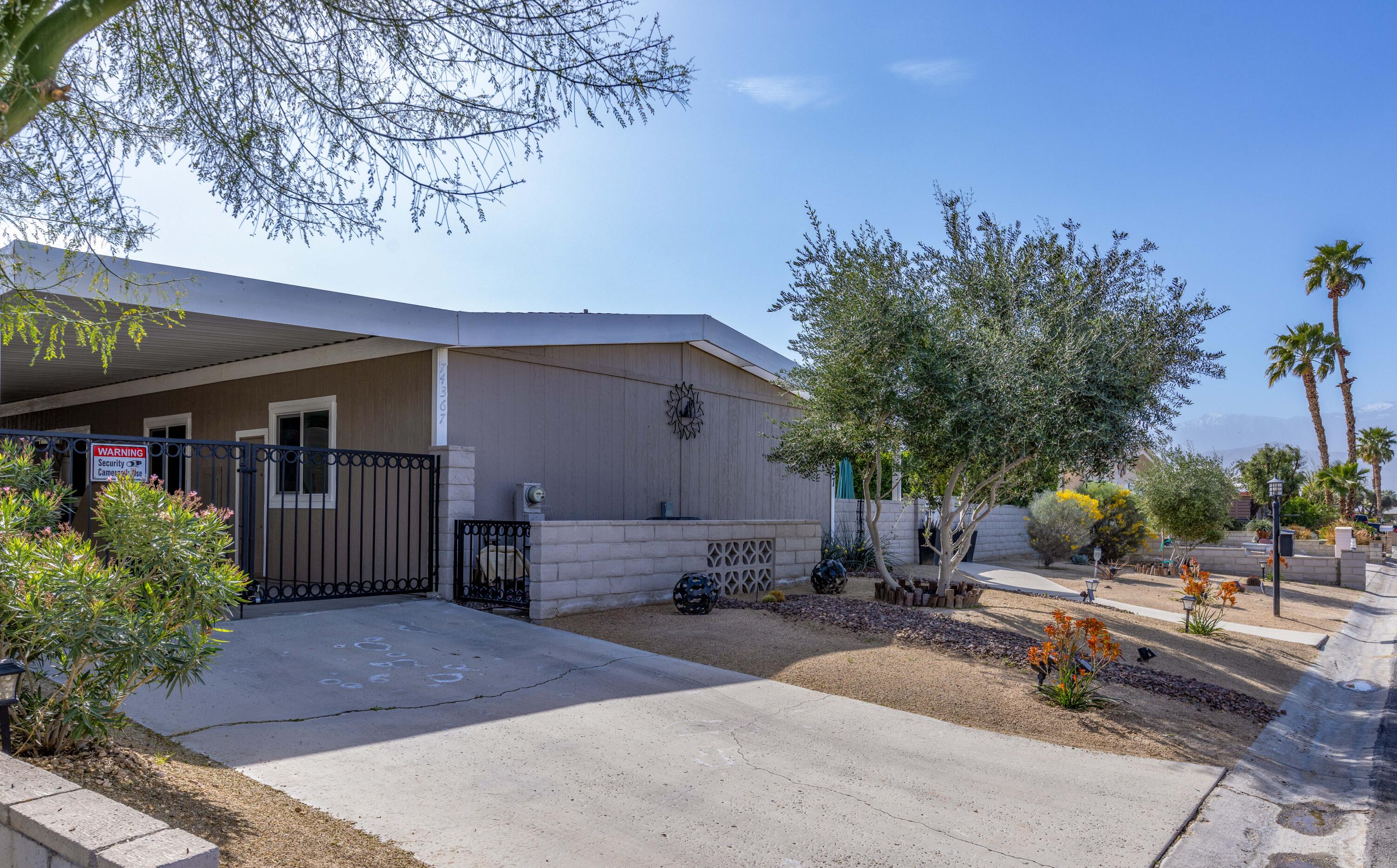 Undisclosed Address Palm Desert, CA 92260 - Photo 2 of 41 a row of palm trees in front of house