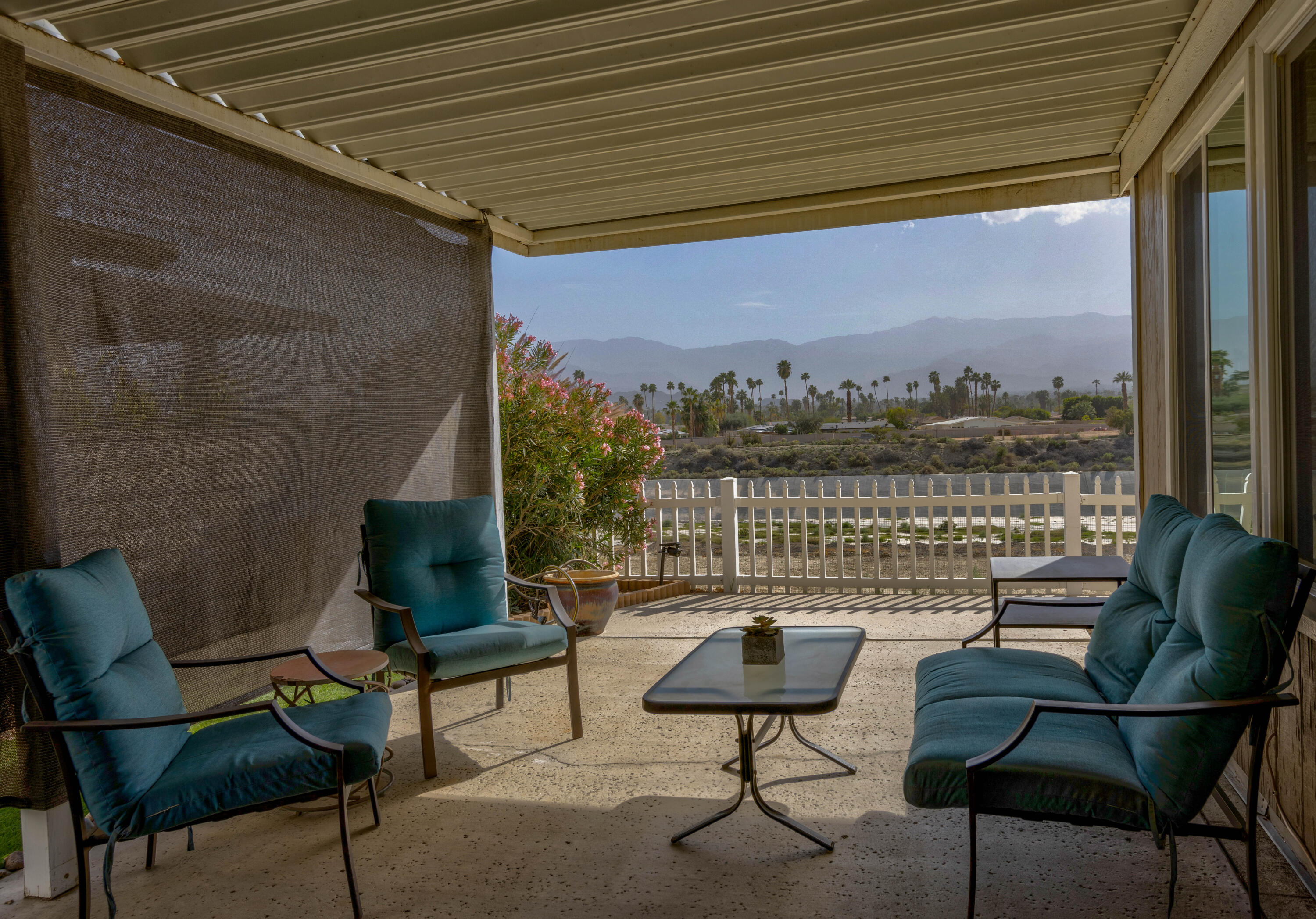 Undisclosed Address Palm Desert, CA 92260 - Photo 27 of 41 a roof deck with a table and chairs