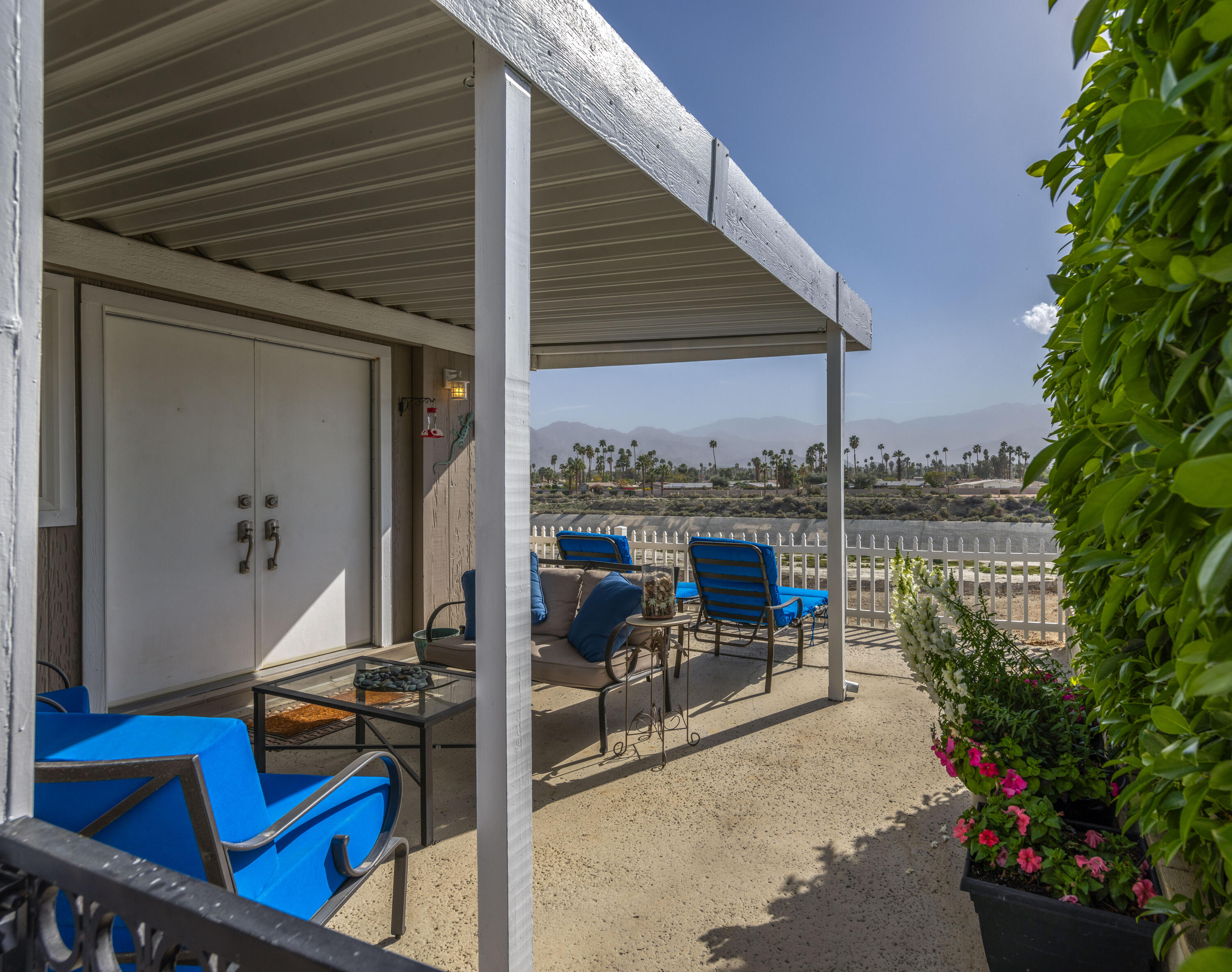 Undisclosed Address Palm Desert, CA 92260 - Photo 3 of 41 a view of a balcony with chairs and potted plants