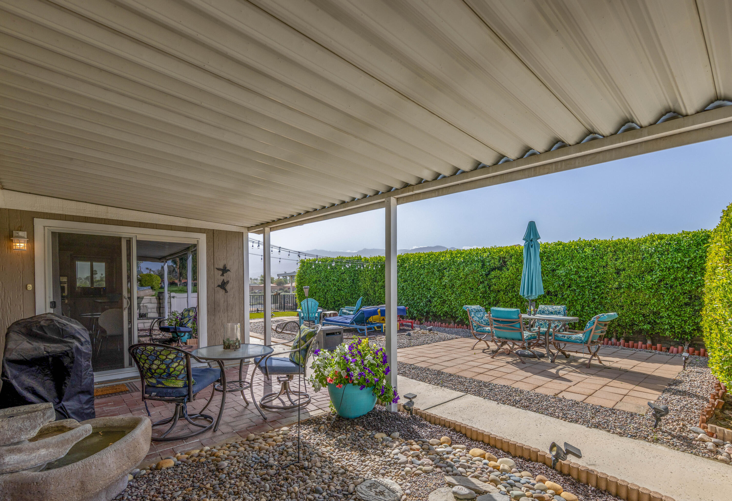 Undisclosed Address Palm Desert, CA 92260 - Photo 32 of 41 a view of a patio with table and chairs potted plants with barbeque grill and floor