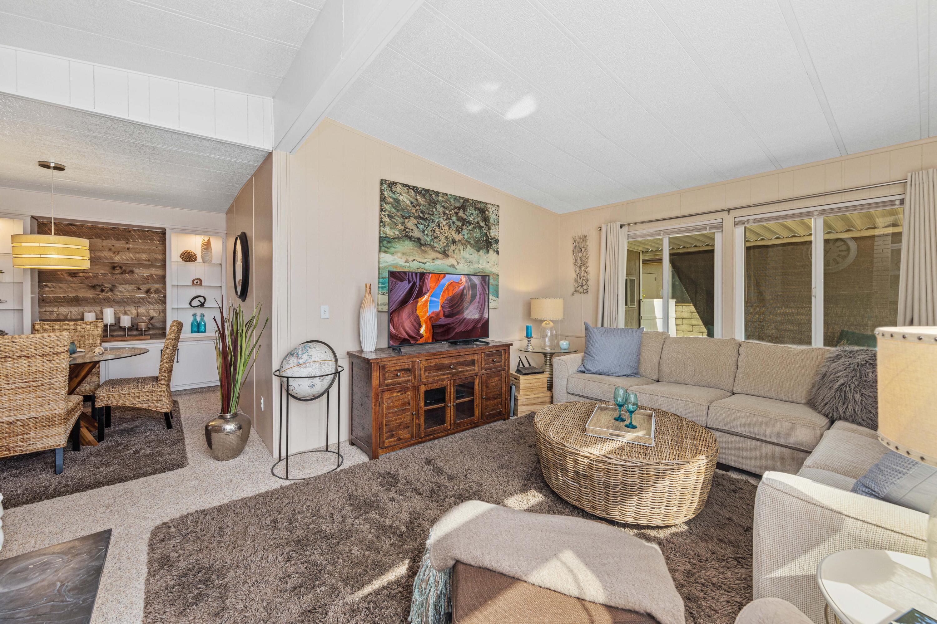 Undisclosed Address Palm Desert, CA 92260 - Photo 7 of 41 a living room with furniture and a flat screen tv