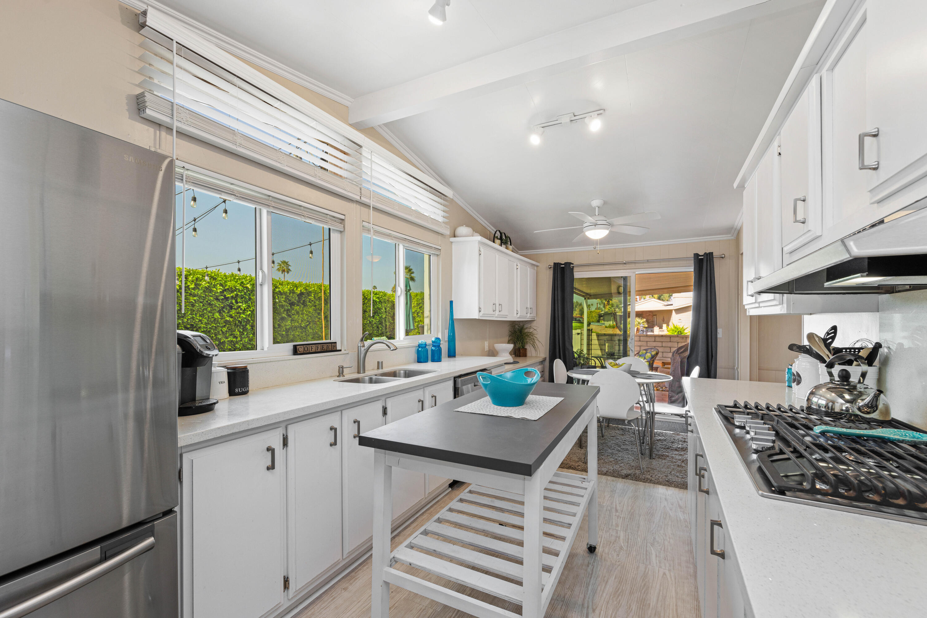 Undisclosed Address Palm Desert, CA 92260 - Photo 10 of 41 a large kitchen with a large window and stainless steel appliances