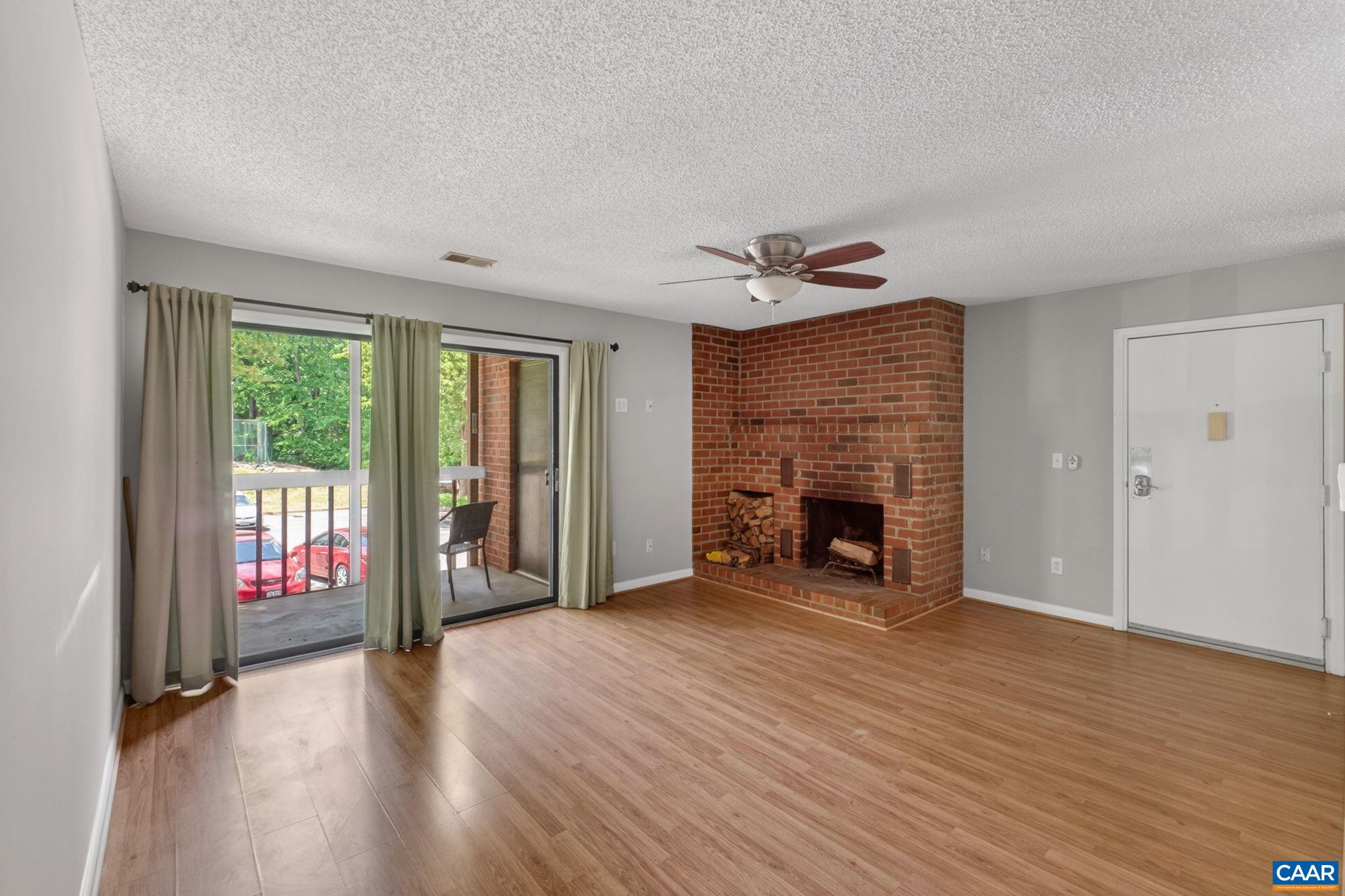 103 Turtle Creek Road, Unit 8 Charlottesville, VA 22901 - Photo 1 of 37 wooden floor fireplace and windows in an empty room