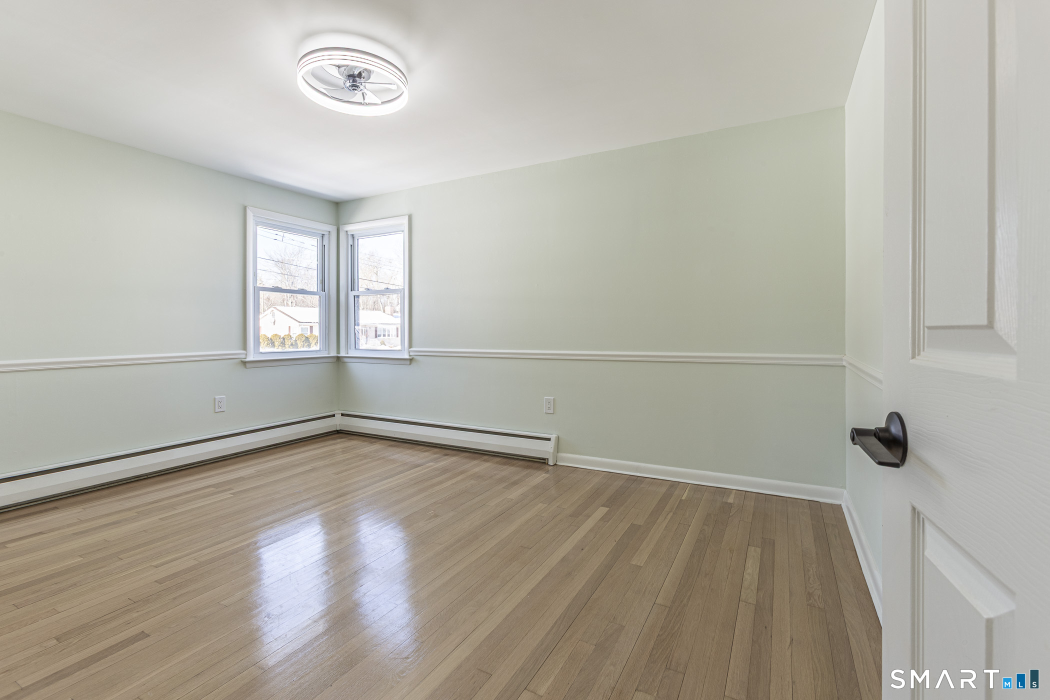 26 Kelly Road Hamden, CT 06518 - Photo 18 of 37 an empty room with wooden floor and windows