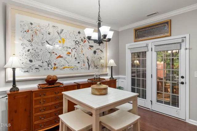 a view of a dining room with furniture and chandelier