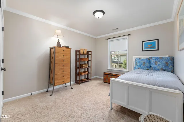 a bedroom with two beds and a large window