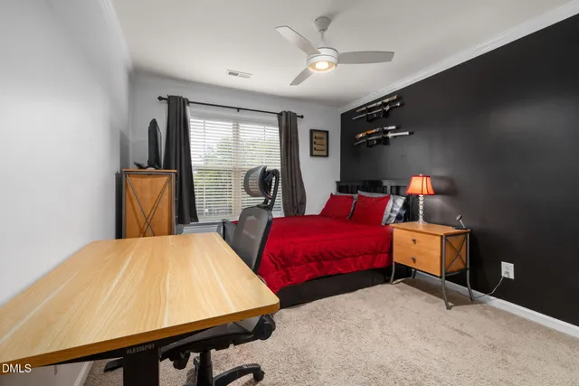 a bedroom with a bed and a desk