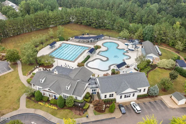an aerial view of residential house with outdoor space and swimming pool