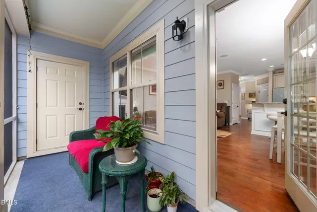 a view of a hallway with dining area and chandelier