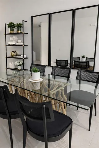 a kitchen with a table chairs and white cabinets