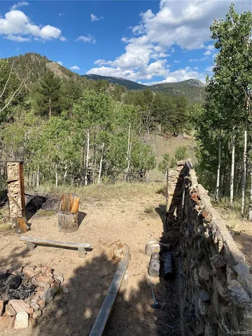 a view of a yard with wooden fence