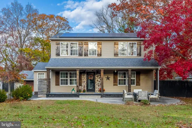 a front view of a house with a garden and patio