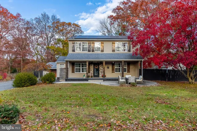 a view of a house with a yard porch and sitting area