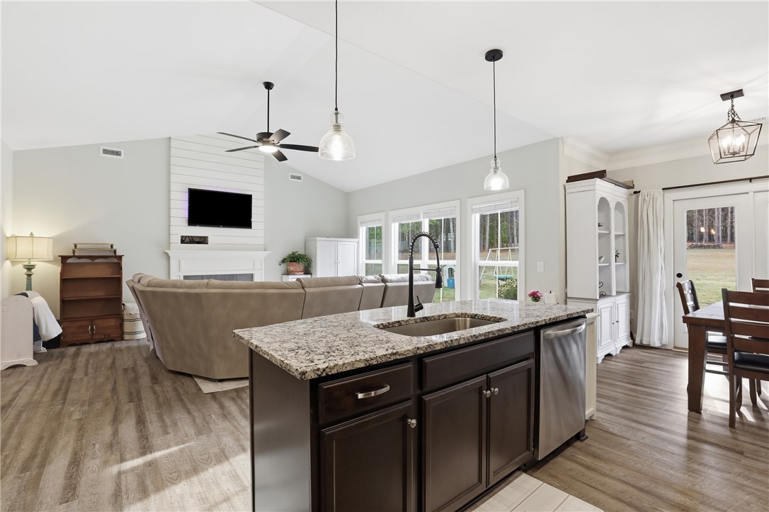 127 West Stewart Street Pelzer, SC 29669 - Photo 5 of 23 This bright, open concept living area seamlessly connects the kitchen and living room.
