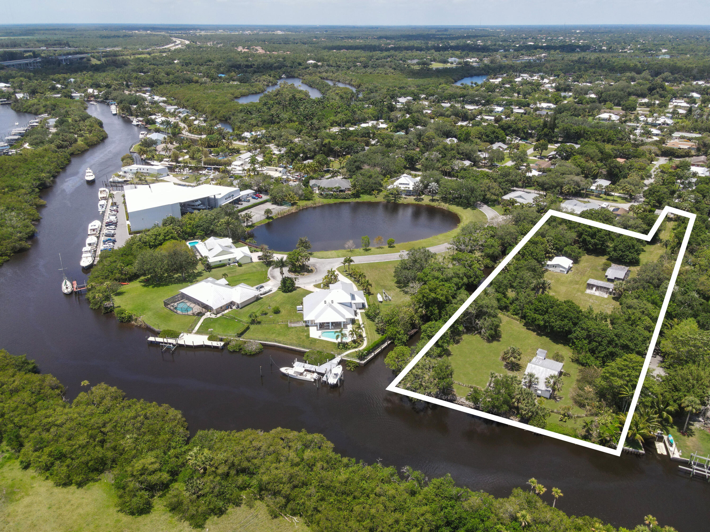 an aerial view of residential houses with outdoor space and river