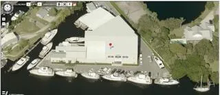 an aerial view of a residential houses with outdoor space and river view