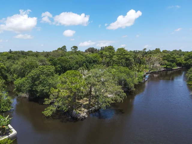 an aerial view of a houses with yard lake and lake view