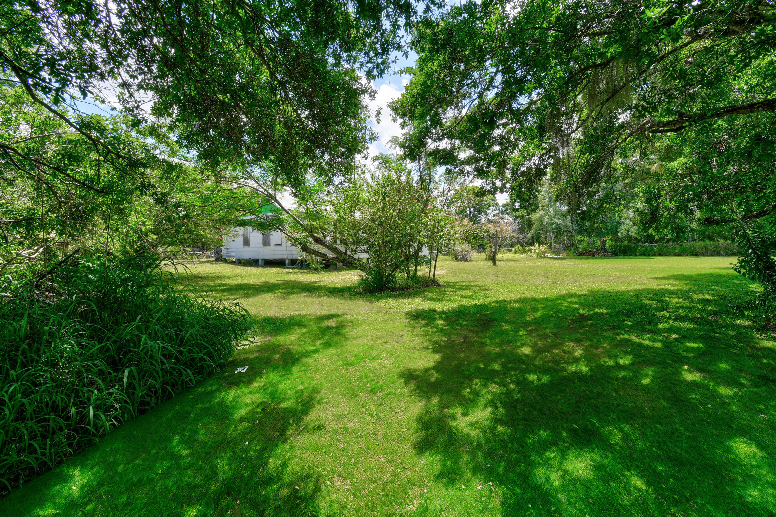 332 Southwest Salerno Road Stuart, FL 34997 - Photo 9 of 17 a view of outdoor space with deck and yard