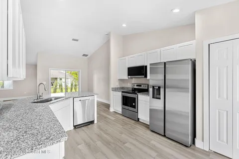 a kitchen with a refrigerator stove and microwave