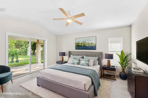 a bedroom with a large bed and a large window
