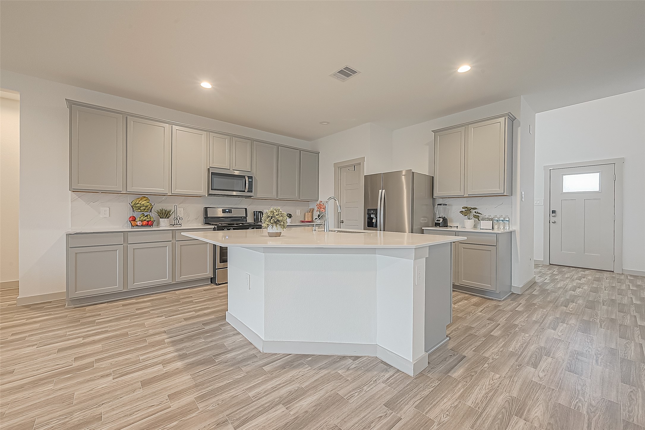 1815 Sandy Trail Lane Rosenberg, TX 77469 - Photo 13 of 47 a kitchen with white cabinets and white appliances