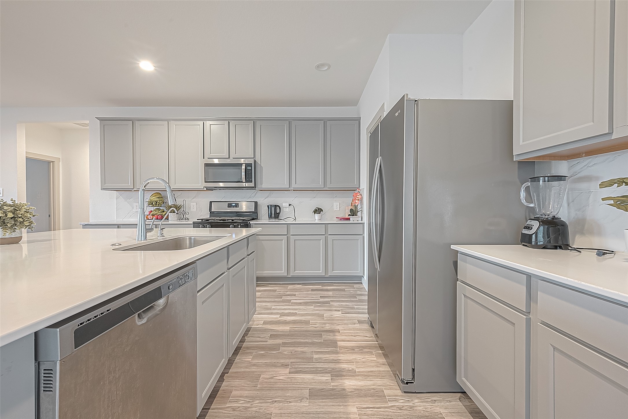 1815 Sandy Trail Lane Rosenberg, TX 77469 - Photo 14 of 47 a kitchen with kitchen island white cabinets appliances and a sink