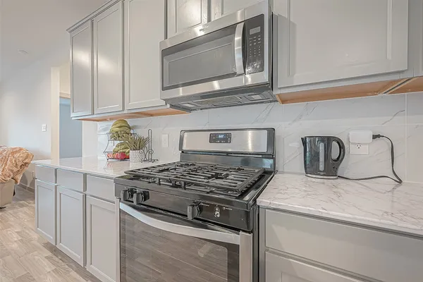 a kitchen with kitchen island white cabinets appliances and a sink