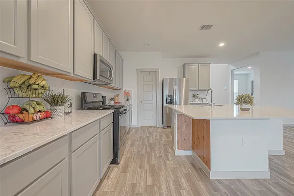 a kitchen with granite countertop stainless steel appliances and cabinets