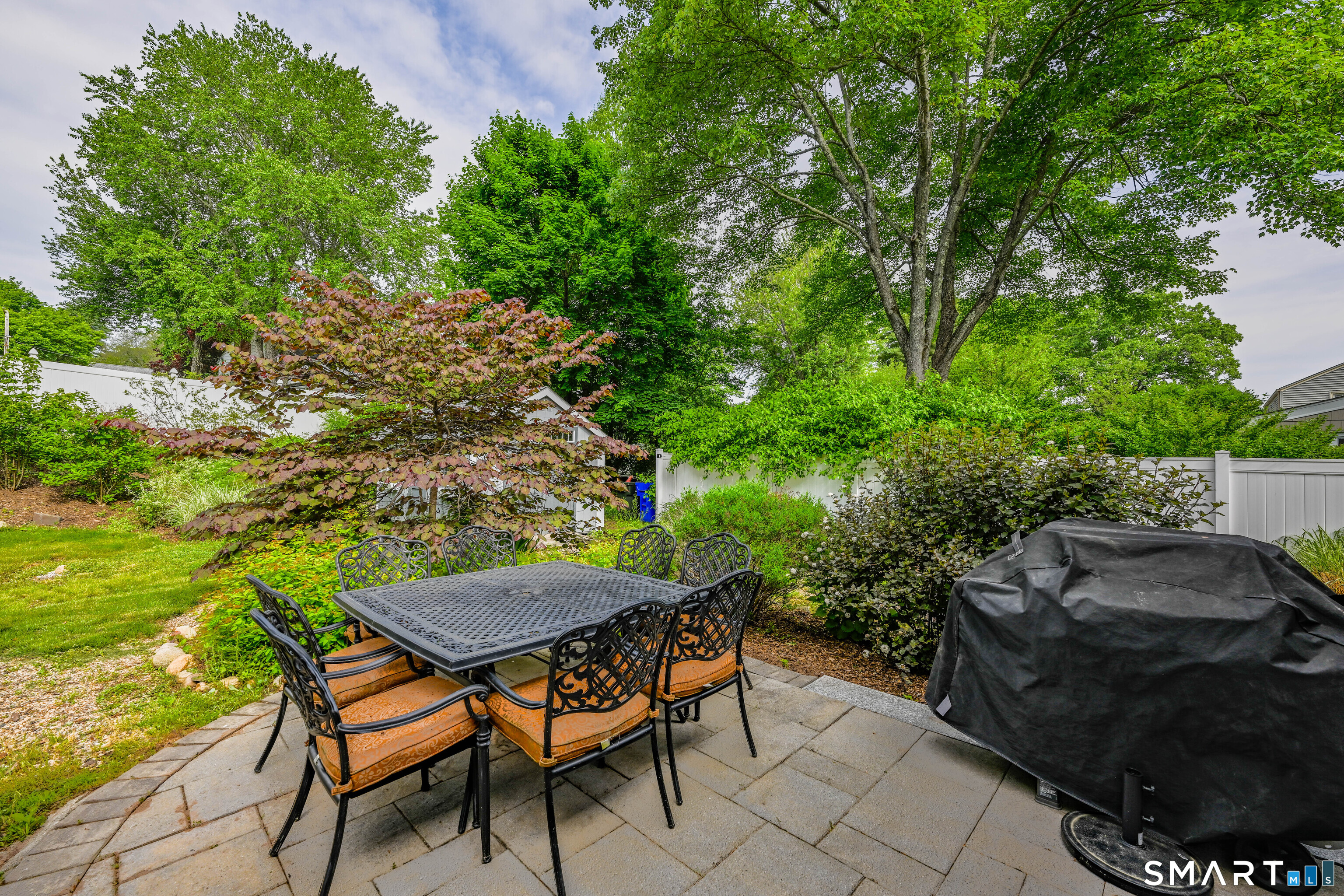 47 Spring Lane West Hartford, CT 06107 - Photo 18 of 38 a backyard of a house with table and chairs