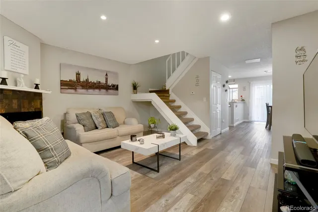 a living room with furniture and wooden floor