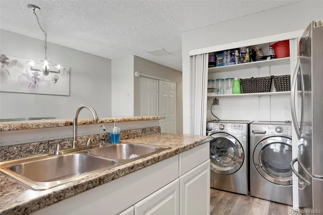 a kitchen with a sink and a stove top oven