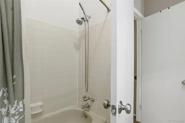 a bathroom with a shower and a bath tub
