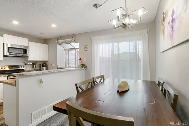 a kitchen with a table chairs and microwave