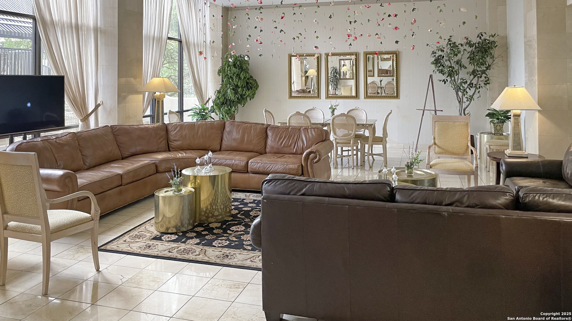 7701 Wurzbach Road, Unit 703 San Antonio, TX 78229 - Photo 17 of 28 a living room with furniture and a flat screen tv