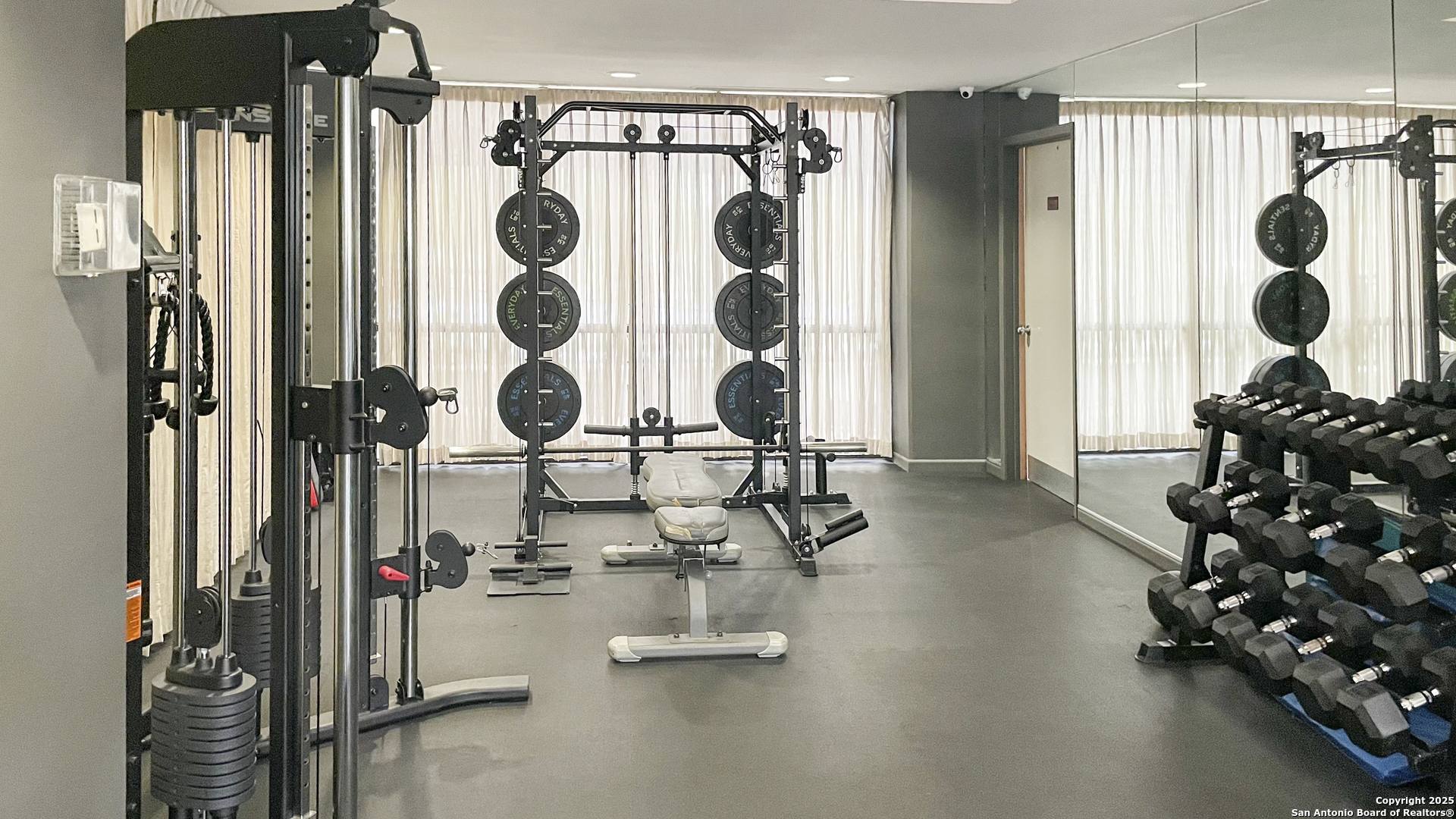 7701 Wurzbach Road, Unit 703 San Antonio, TX 78229 - Photo 23 of 28 a room with gym equipment and mirrors