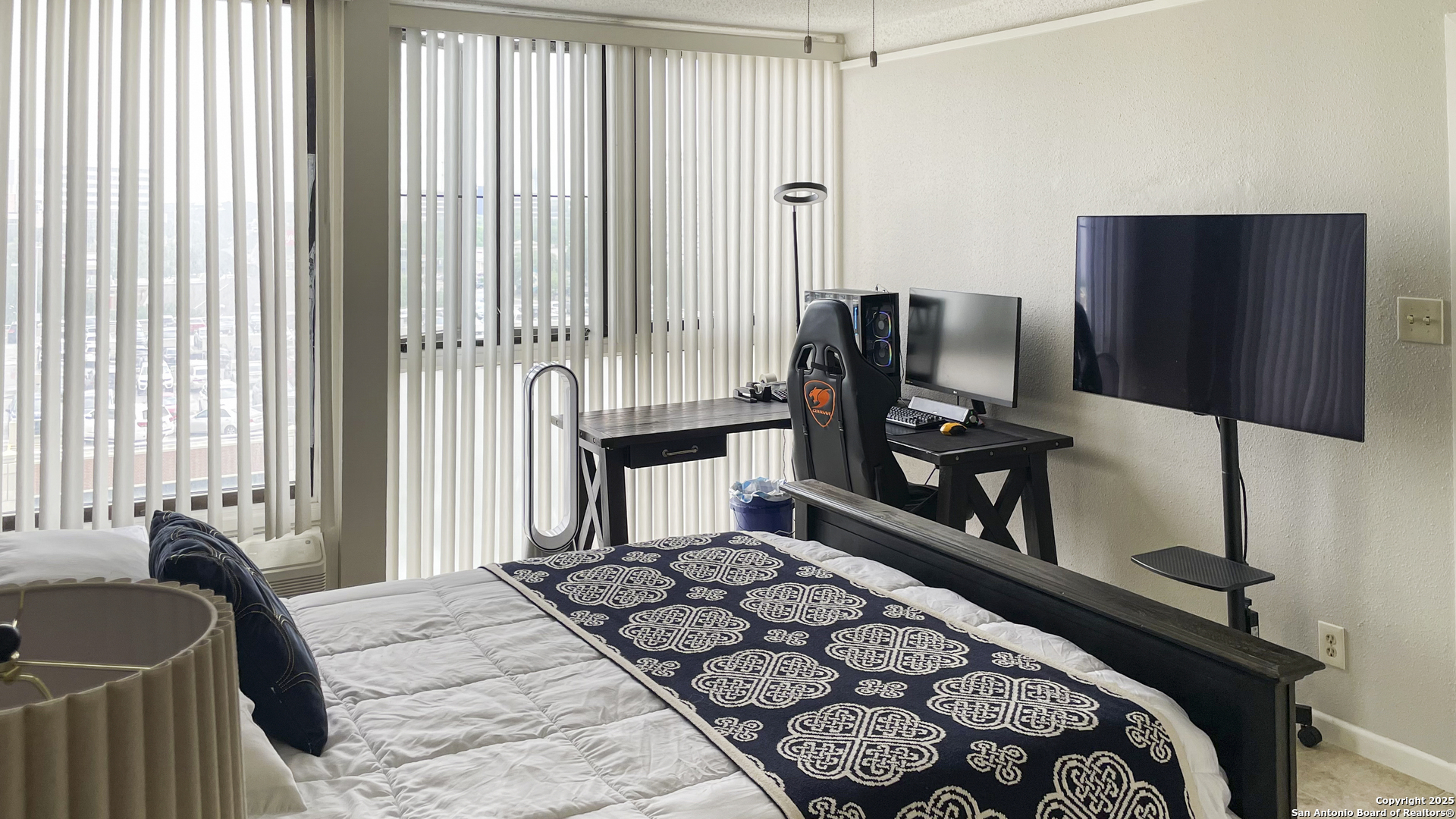 7701 Wurzbach Road, Unit 703 San Antonio, TX 78229 - Photo 5 of 28 a bedroom with a bed tv and a window