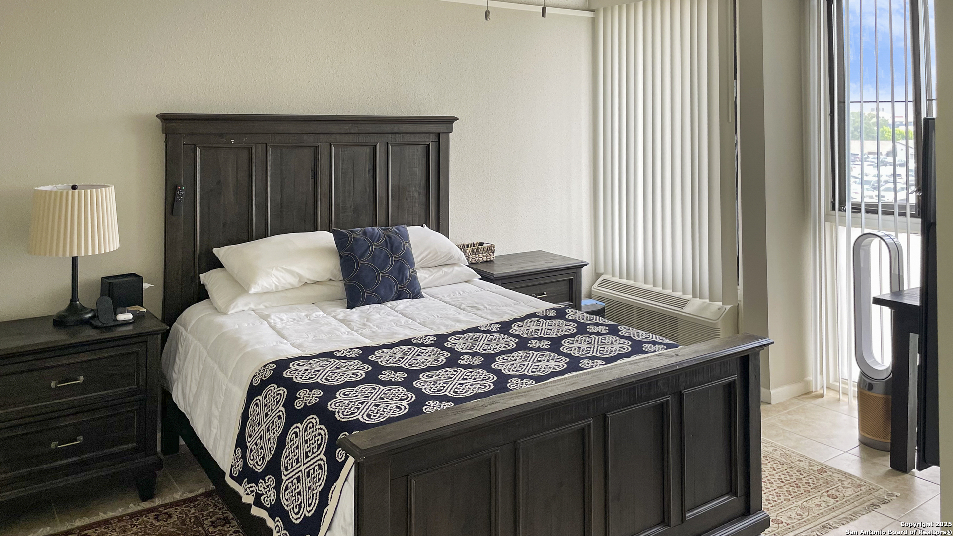 7701 Wurzbach Road, Unit 703 San Antonio, TX 78229 - Photo 6 of 28 a bedroom with a bed and a window