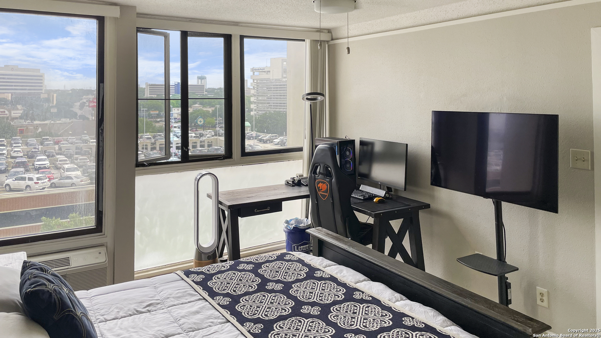 7701 Wurzbach Road, Unit 703 San Antonio, TX 78229 - Photo 7 of 28 a living room with furniture and a flat screen tv