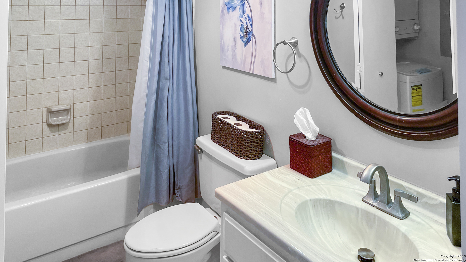 7701 Wurzbach Road, Unit 703 San Antonio, TX 78229 - Photo 8 of 28 a bathroom with a sink a toilet and a mirror