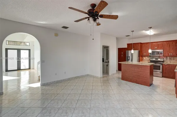 a view of kitchen with cabinets and window