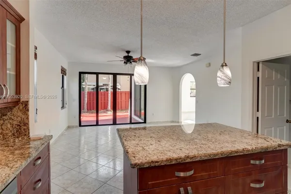 a view of a kitchen with a sink and a mirror