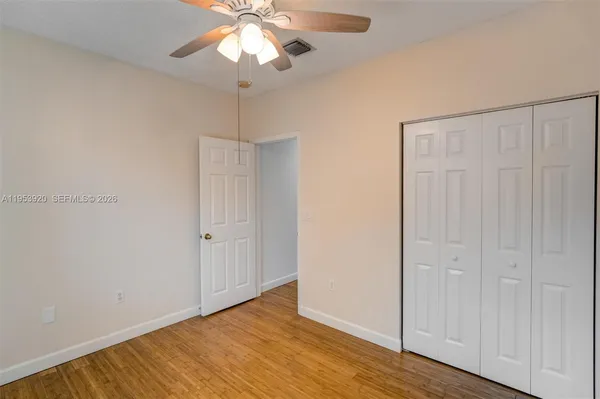 a view of an empty room with wooden floor