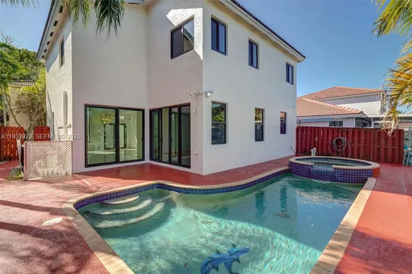 a swimming pool with yard and outdoor seating