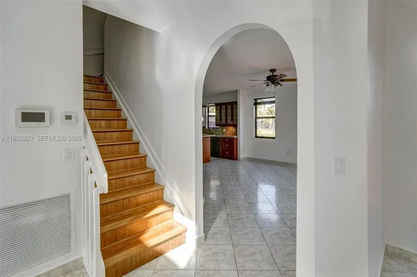 a view of entryway and hall with wooden floor