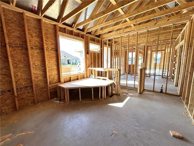 a spacious bedroom with a large bed and large windows