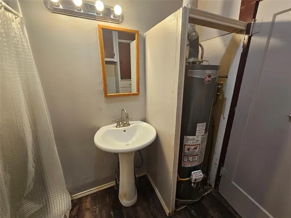 a bathroom with a toilet and a mirror