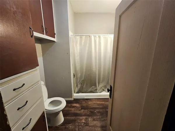 a bathroom with a shower and a sink