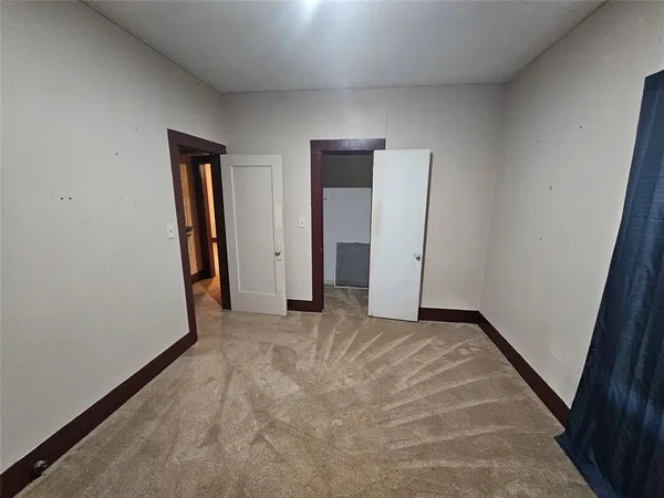 a view of an empty room and closet area