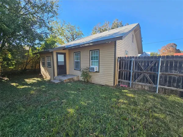 a view of a house with yard and a garden