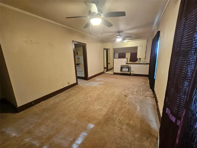 a view of a livingroom with furniture and a ceiling fan